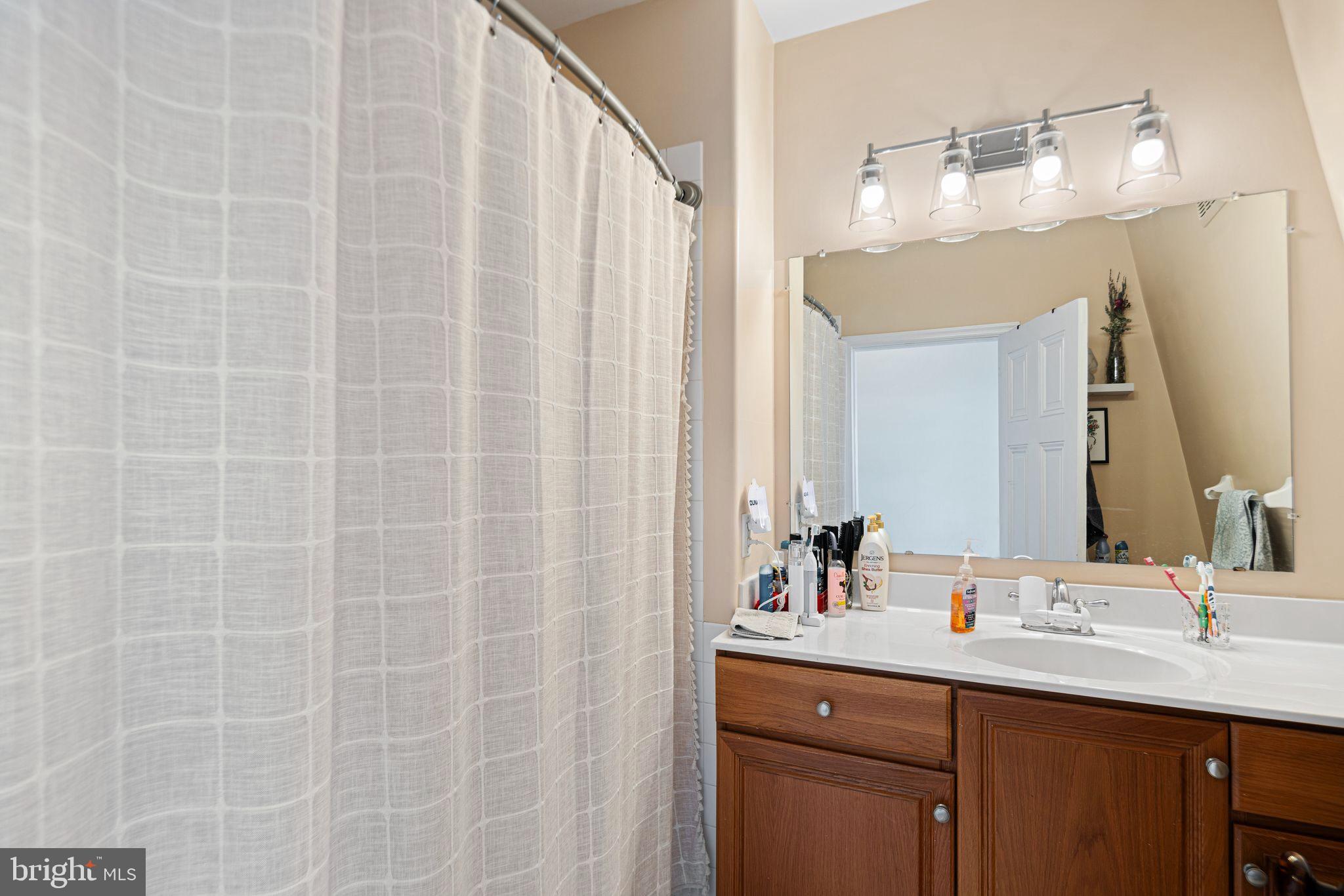 1935 Spring Garden Street Philadelphia, PA 19130 - Photo 46 of 49 a bathroom with a double vanity sink and a mirror