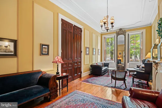 a living room with furniture and a chandelier