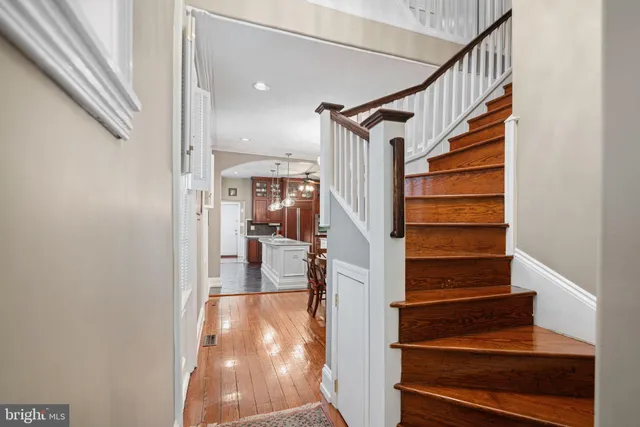 a view of entryway and hall with wooden floor