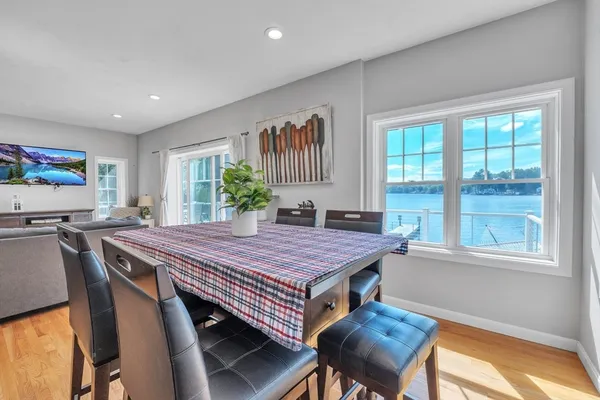 a dining room with a table chairs and a bed