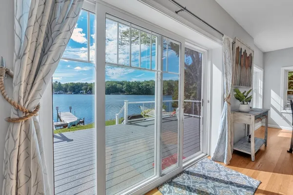 a balcony view with a potted plant and a glass door