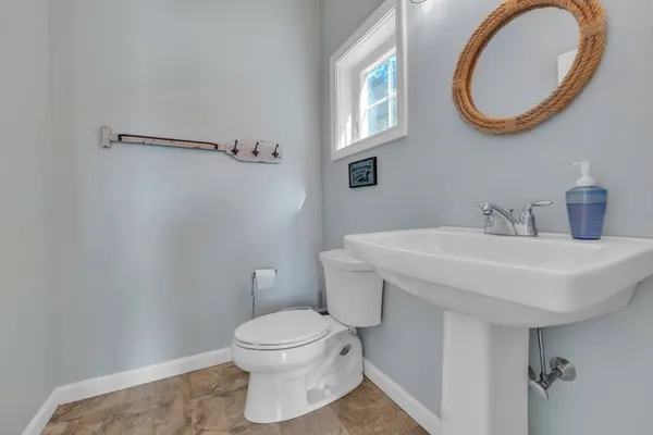 a bathroom with a sink a mirror and a toilet