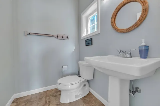 a bathroom with a sink a mirror and a toilet