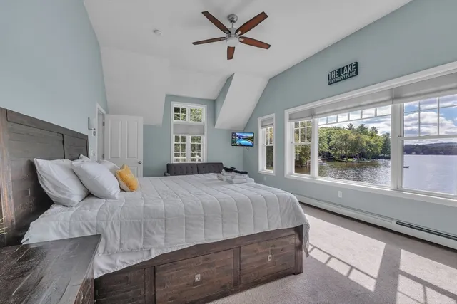a spacious bedroom with a bed and window