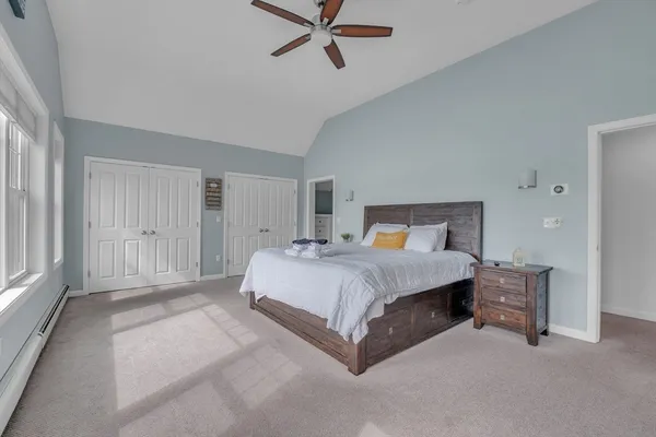 a bedroom with a large bed and a large window