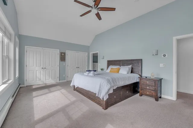 a bedroom with a large bed and a large window