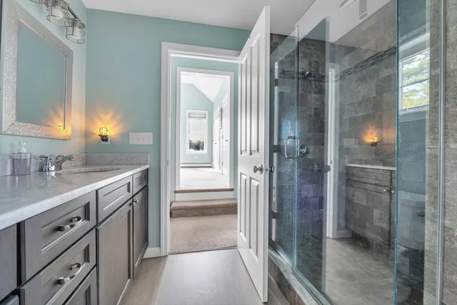 a bathroom with a granite countertop sink and a mirror