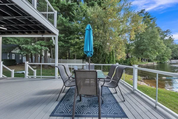 a view of a backyard with brick wall and potted plants