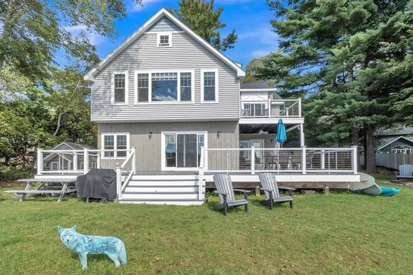 a front view of a house with a yard table and chairs