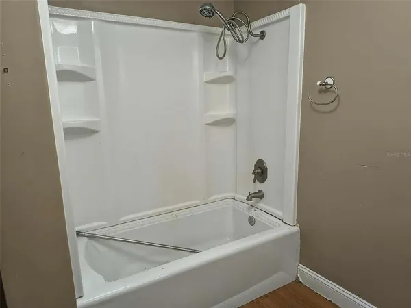 a bathroom with a tub and shower