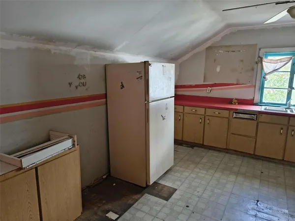 a kitchen with a refrigerator and a sink