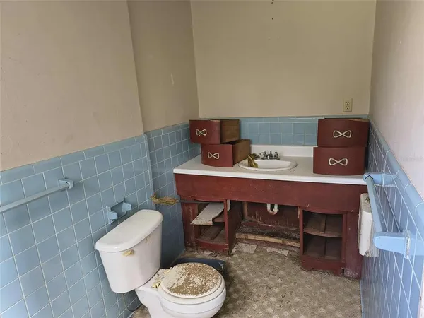 a bathroom with a toilet a sink and a mirror