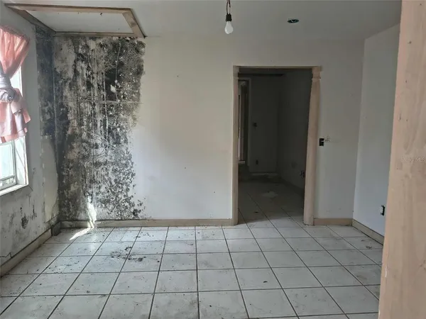 a view of an empty room and window