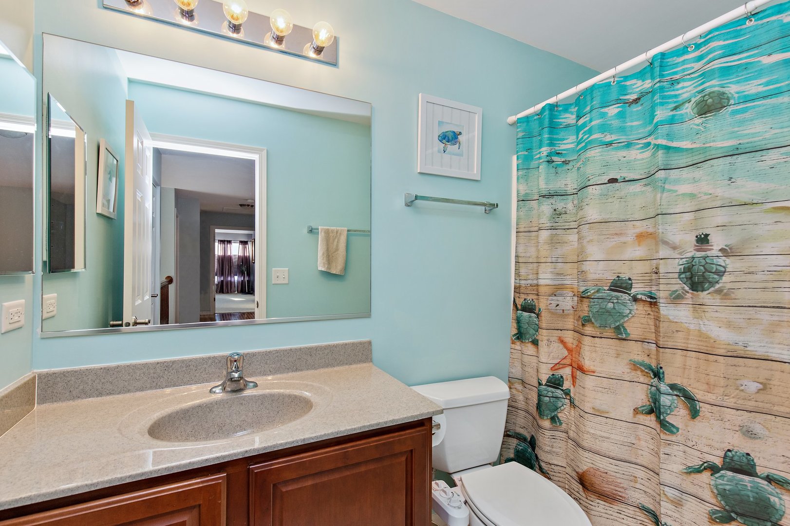 5617 Red Oak Drive Hoffman Estates, IL 60192 - Photo 18 of 30 a bathroom with a sink a toilet and shower curtain