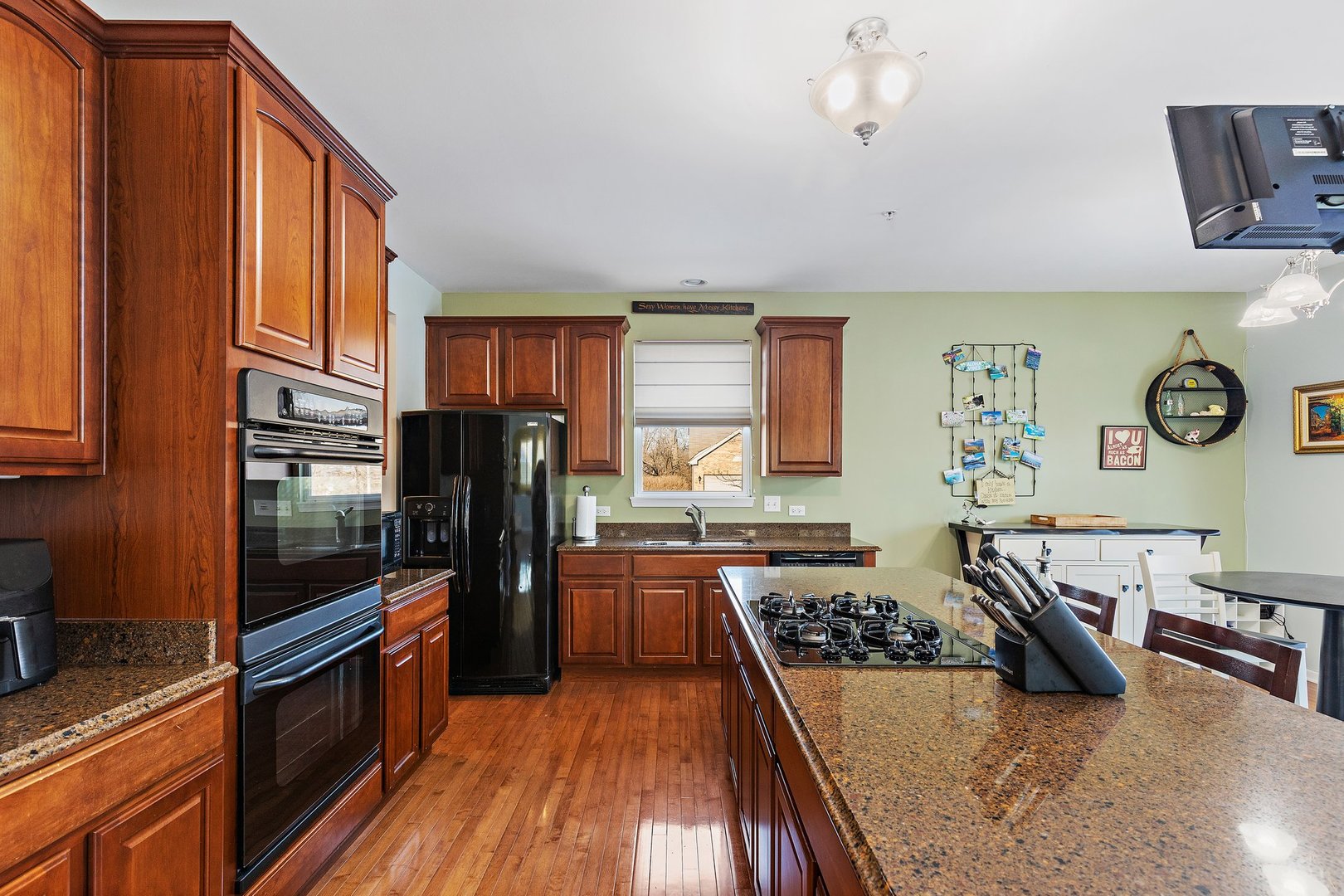 5617 Red Oak Drive Hoffman Estates, IL 60192 - Photo 9 of 30 a kitchen with stainless steel appliances a stove a refrigerator a sink a counter space and wooden floor