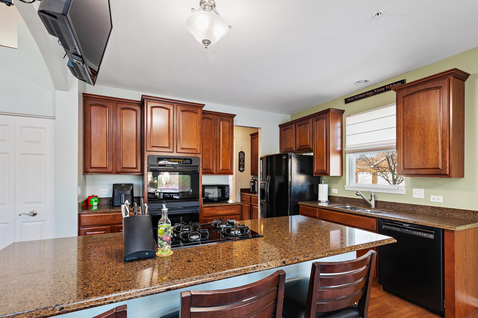 5617 Red Oak Drive Hoffman Estates, IL 60192 - Photo 10 of 30 a kitchen with stainless steel appliances granite countertop a sink a stove and a refrigerator