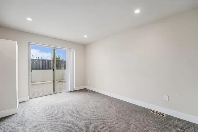 a view of an empty room with glass door