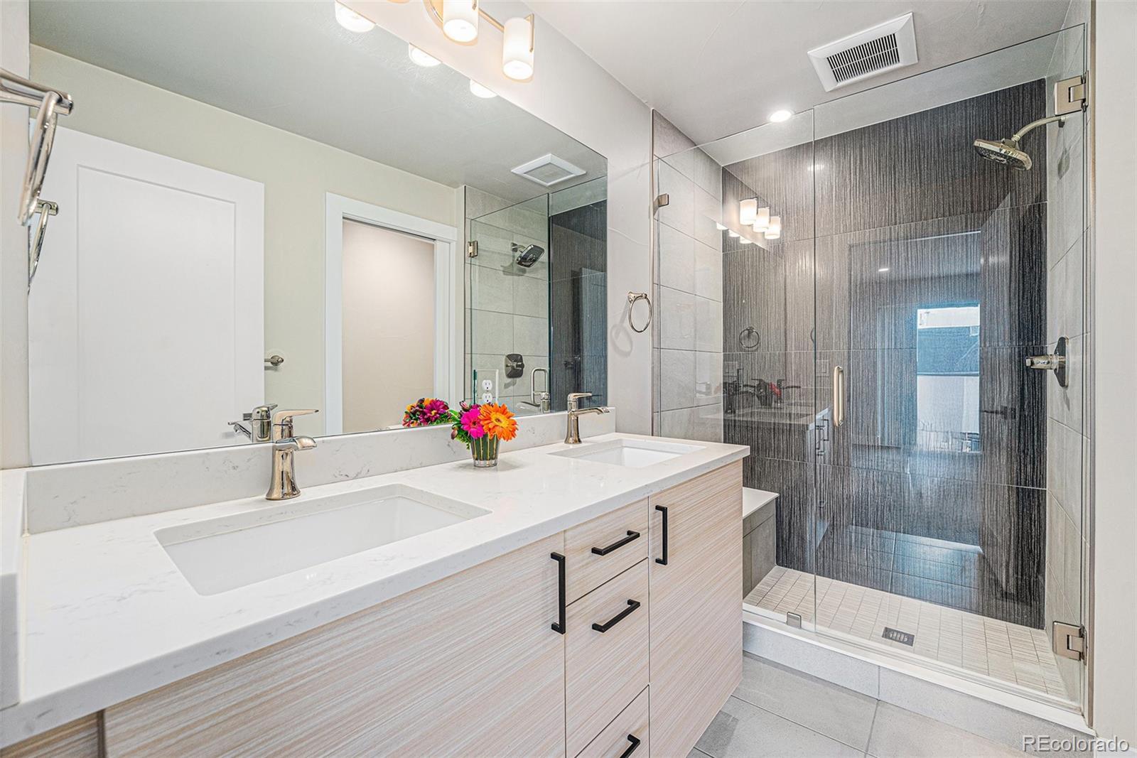 409 Harrison Street, Unit 2 Denver, CO 80206 - Photo 12 of 19 a bathroom with a sink shower and a mirror