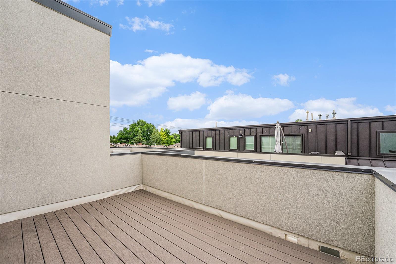 409 Harrison Street, Unit 2 Denver, CO 80206 - Photo 13 of 19 a view of a balcony with wooden floor and a floor to ceiling window