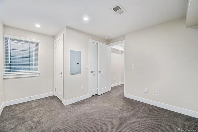 a view of an empty room and a window