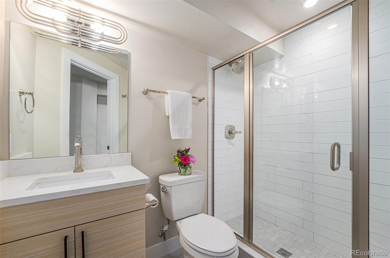 409 Harrison Street, Unit 2 Denver, CO 80206 - Photo 19 of 19 a bathroom with a sink toilet and shower