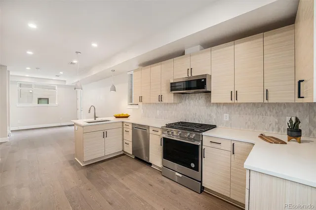 a kitchen with a stove a sink and a refrigerator