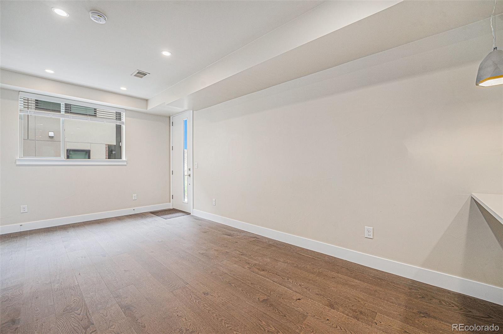 409 Harrison Street, Unit 2 Denver, CO 80206 - Photo 4 of 19 wooden floor in an empty room