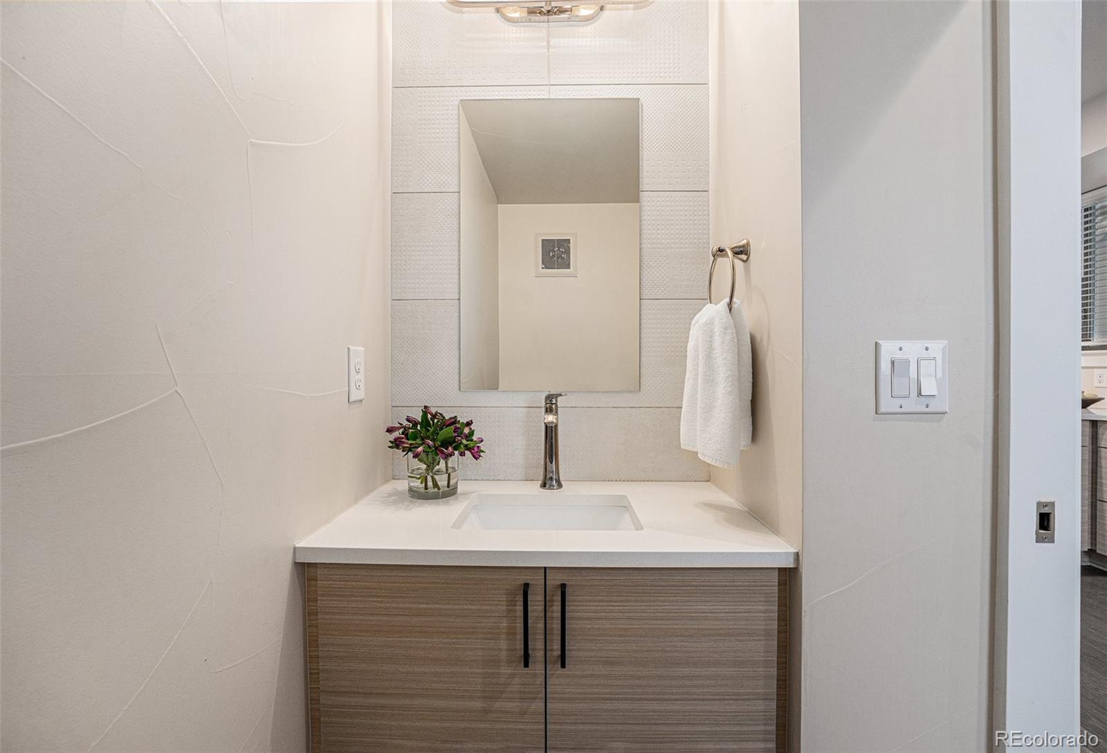 409 Harrison Street, Unit 2 Denver, CO 80206 - Photo 6 of 19 a bathroom with a sink and a mirror