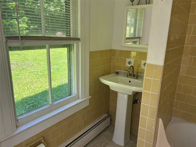 a bathroom with a sink and a window