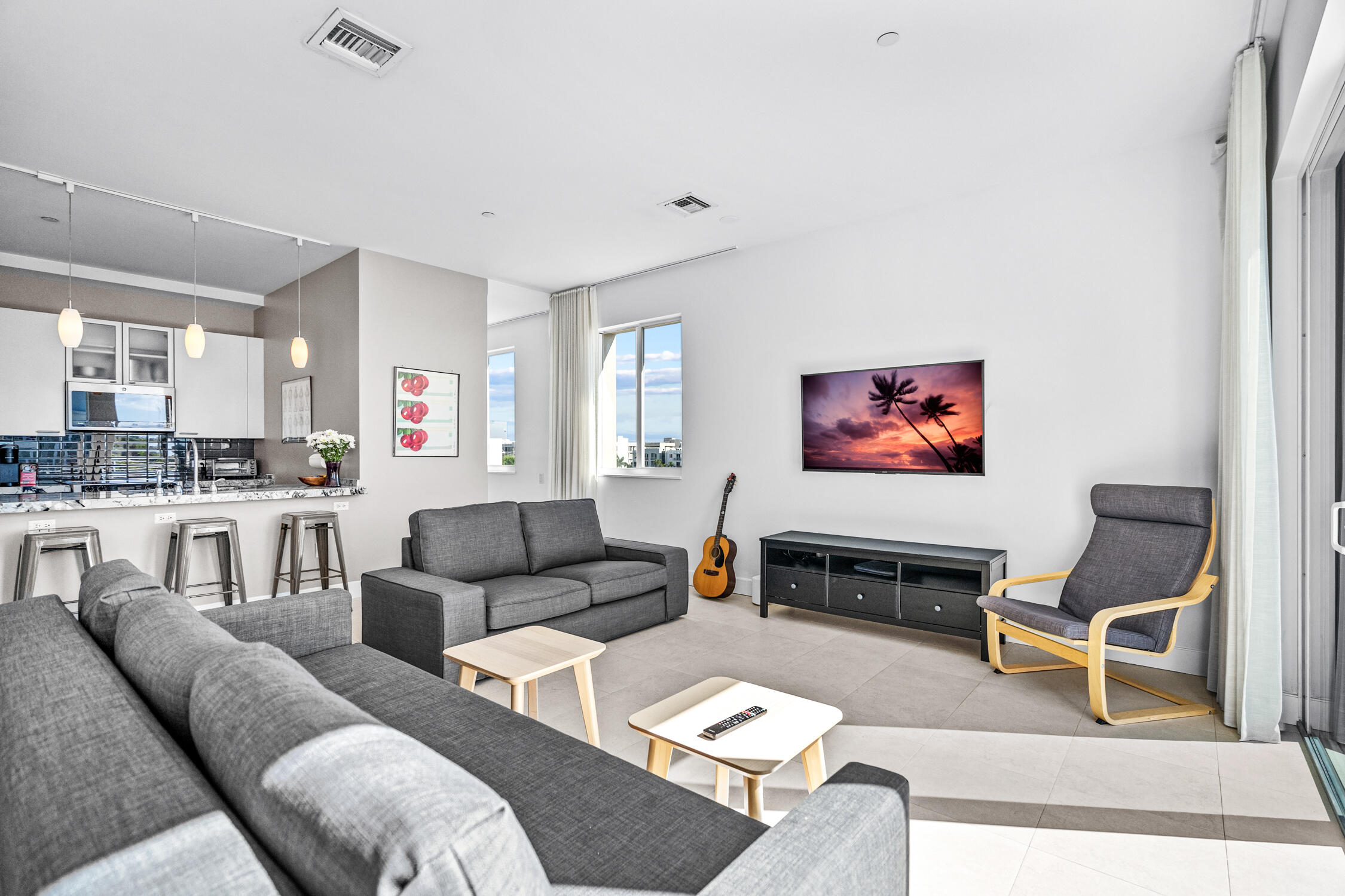 111 Southeast 2nd Street, Unit 401 Delray Beach, FL 33444 - Photo 11 of 38 a living room with furniture and a kitchen view