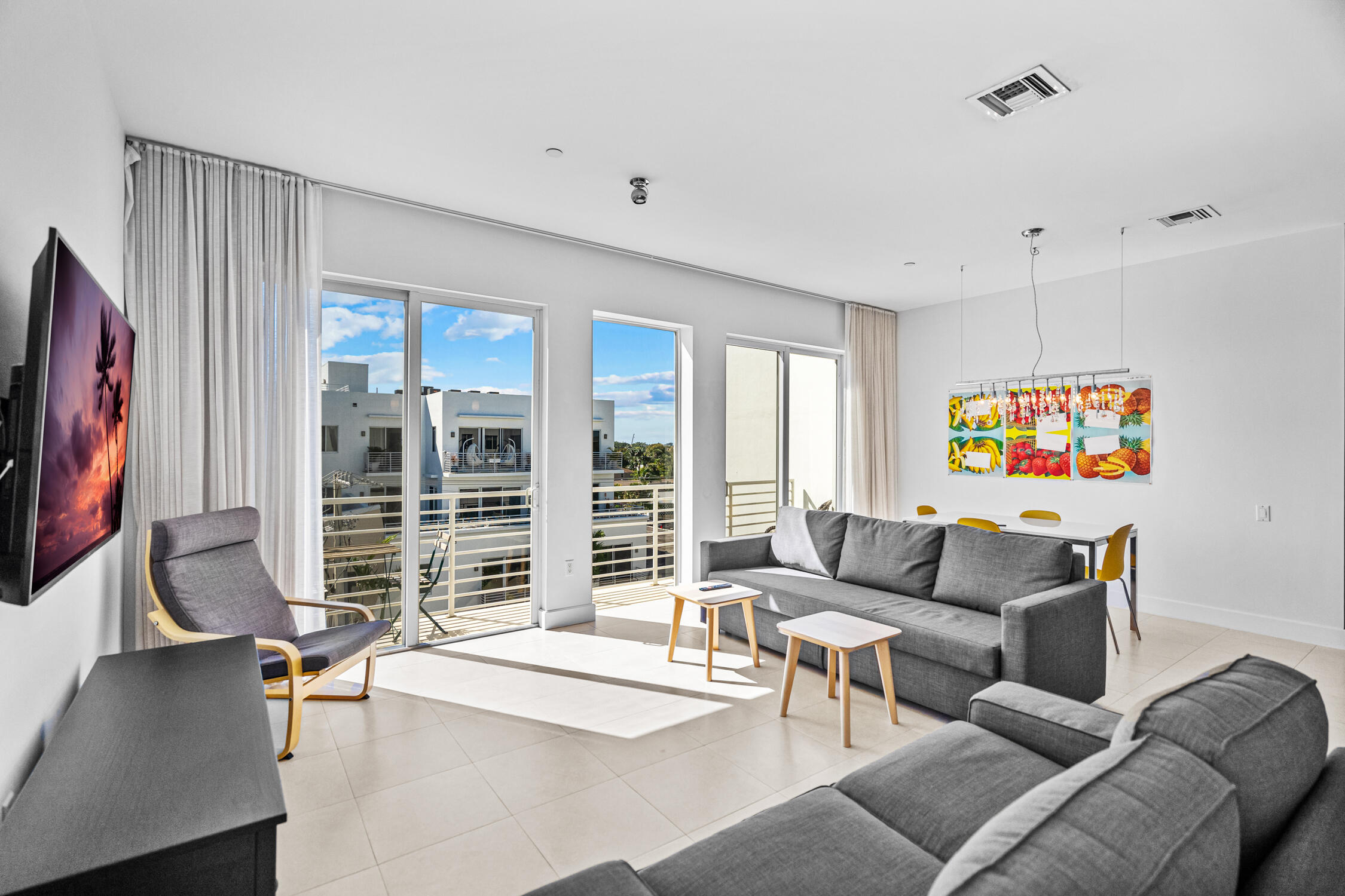 111 Southeast 2nd Street, Unit 401 Delray Beach, FL 33444 - Photo 17 of 38 a living room with furniture and a flat screen tv