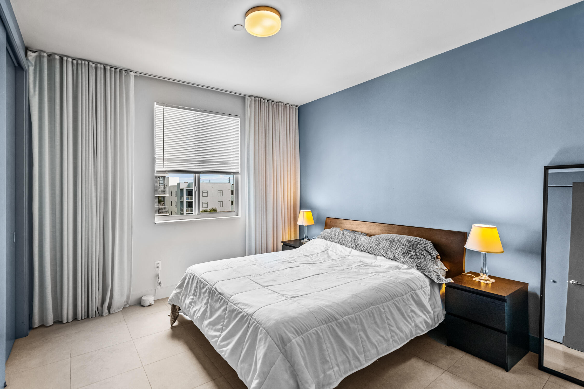 111 Southeast 2nd Street, Unit 401 Delray Beach, FL 33444 - Photo 2 of 38 a bedroom with a bed and a window