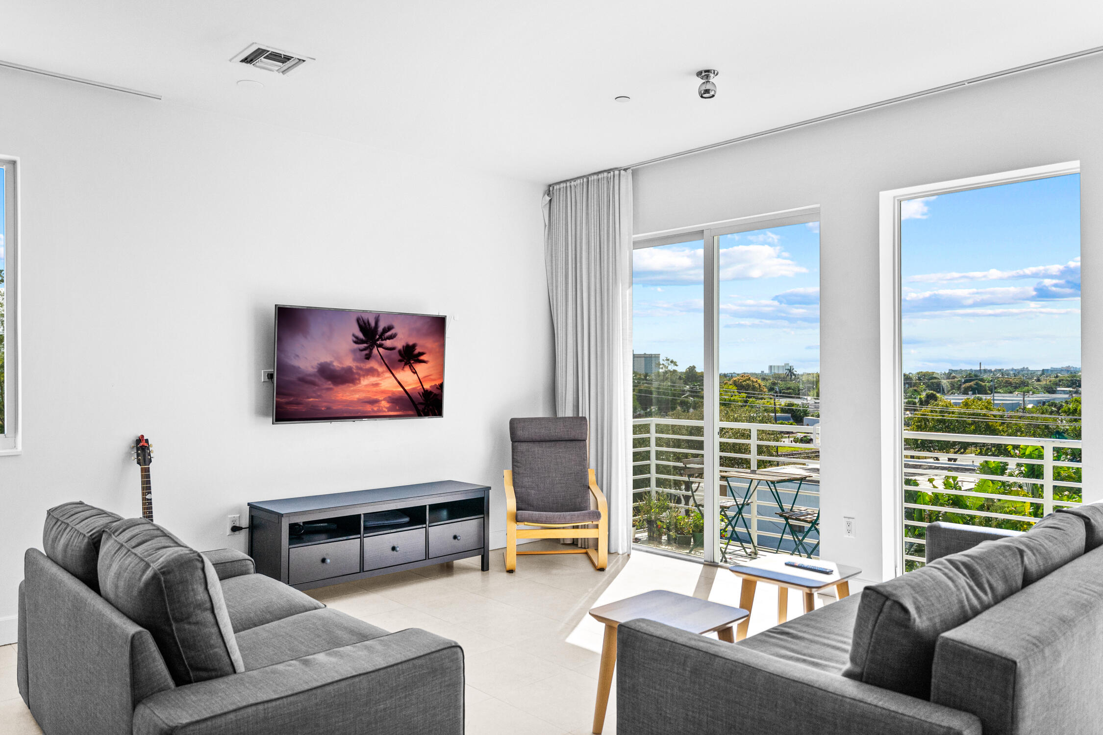 111 Southeast 2nd Street, Unit 401 Delray Beach, FL 33444 - Photo 21 of 38 a living room with furniture a window and a flat screen tv