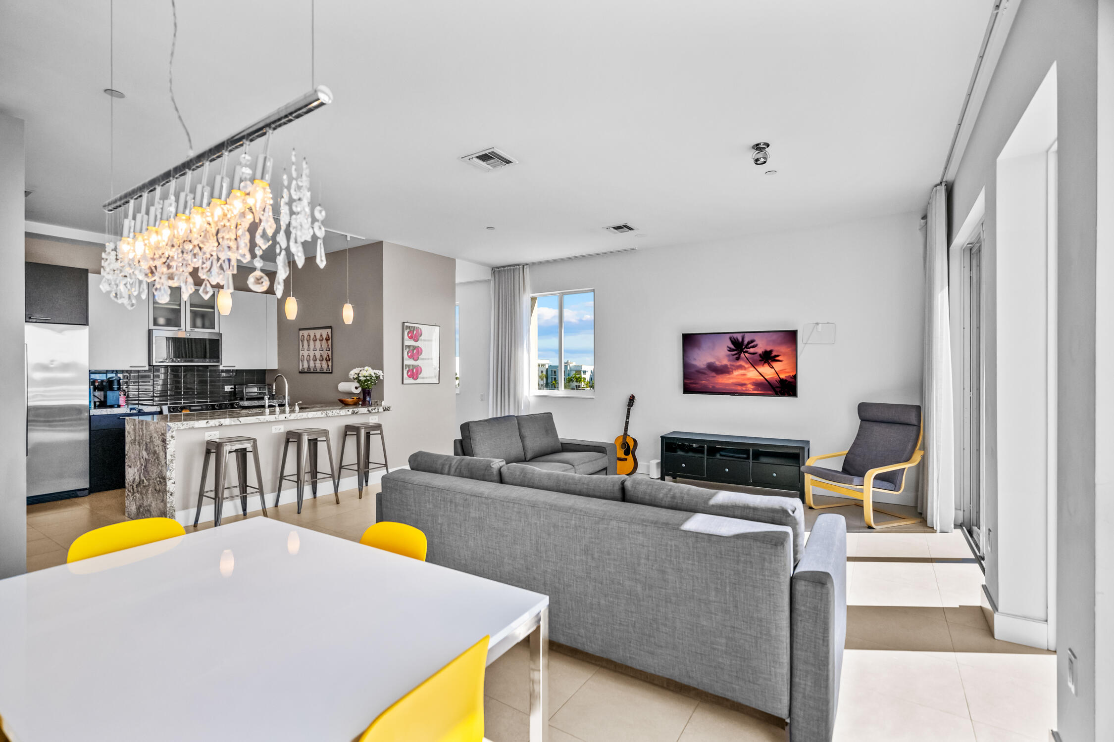 111 Southeast 2nd Street, Unit 401 Delray Beach, FL 33444 - Photo 25 of 38 a living room with furniture and a flat screen tv