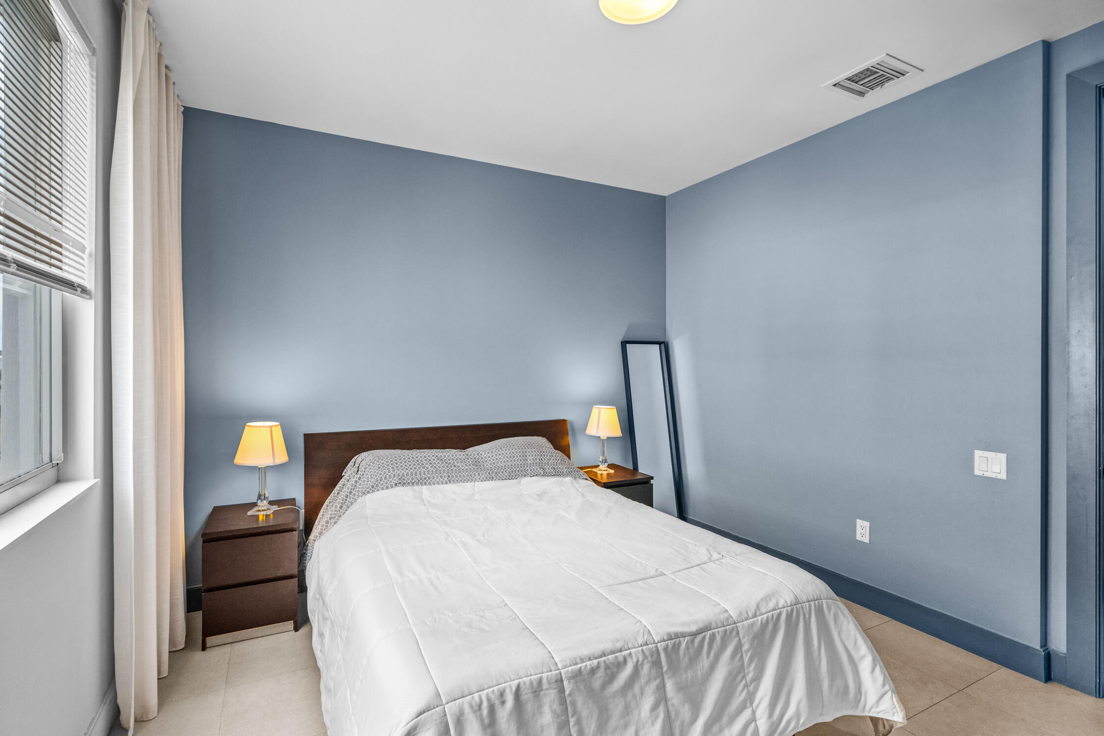 111 Southeast 2nd Street, Unit 401 Delray Beach, FL 33444 - Photo 3 of 38 a bedroom with a bed and window