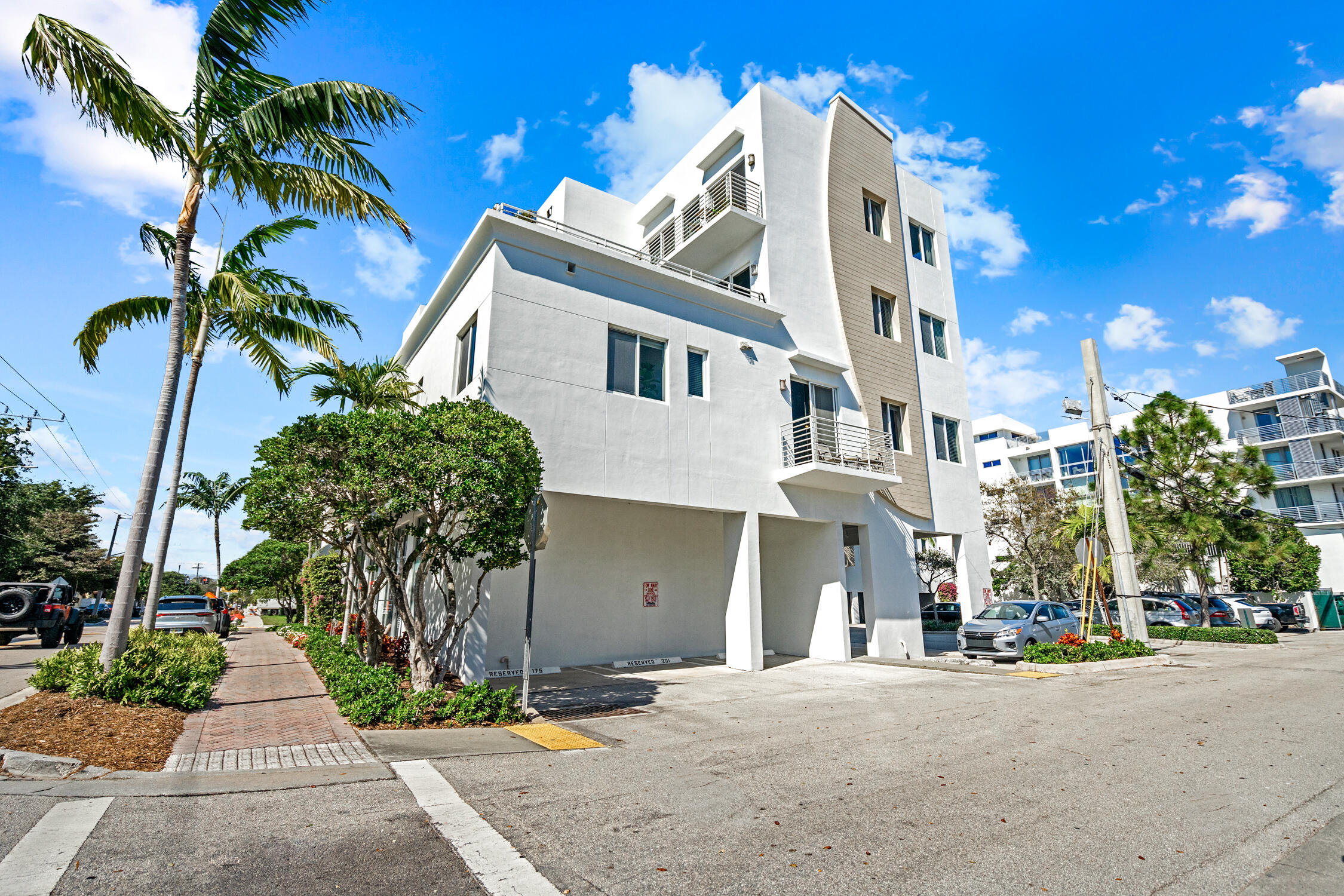 111 Southeast 2nd Street, Unit 401 Delray Beach, FL 33444 - Photo 35 of 38 a front view of a house with a yard and garage