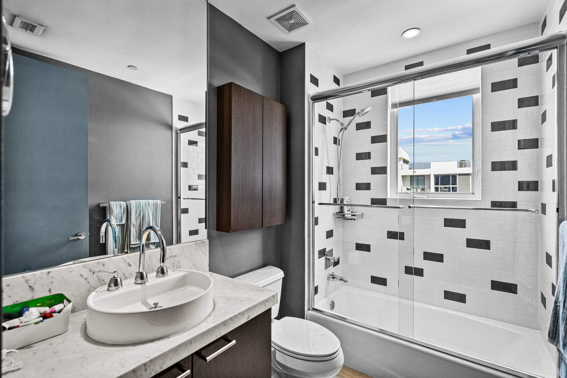 111 Southeast 2nd Street, Unit 401 Delray Beach, FL 33444 - Photo 4 of 38 a bathroom with a sink a toilet and shower