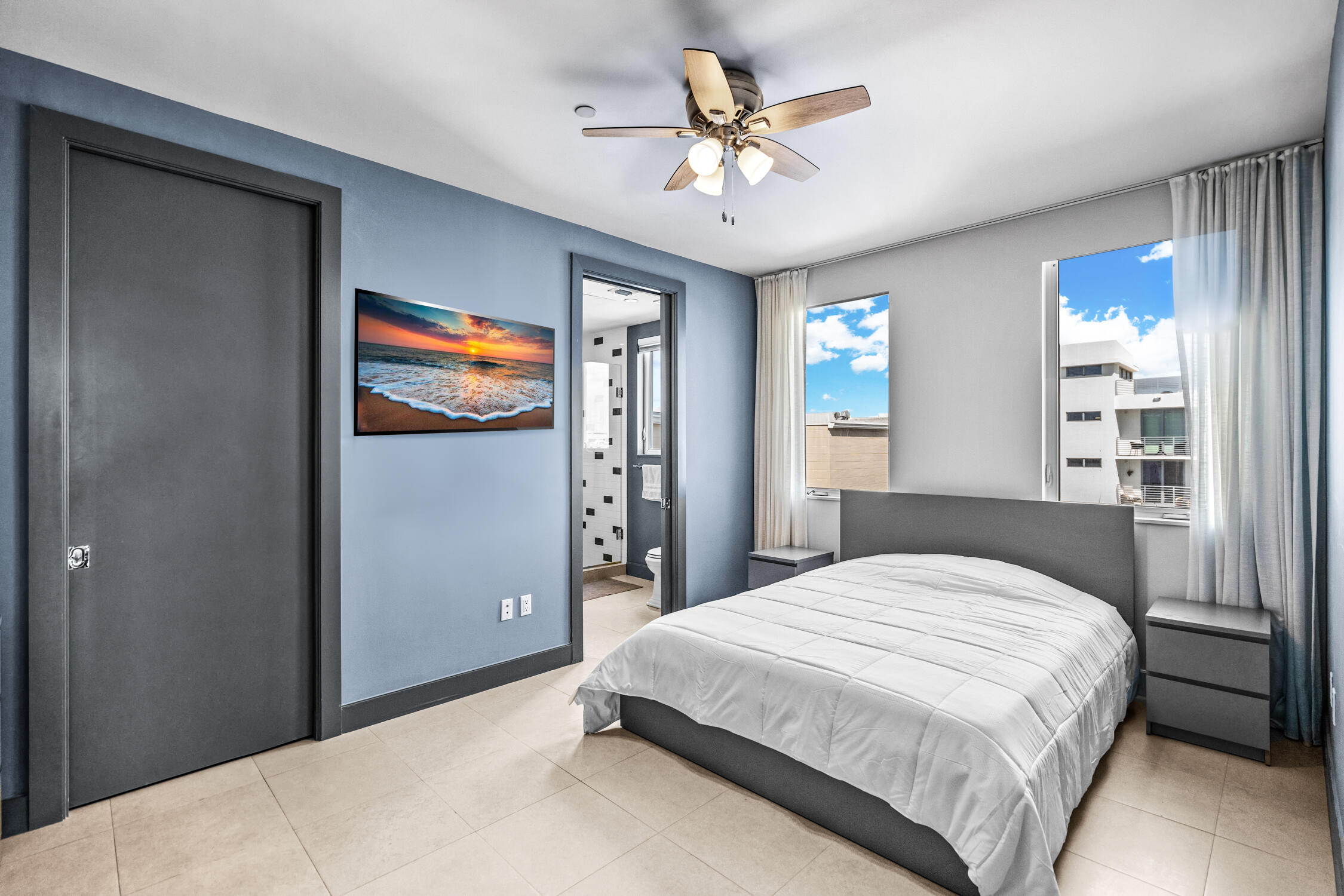 111 Southeast 2nd Street, Unit 401 Delray Beach, FL 33444 - Photo 5 of 38 a bedroom with a bed and a chandelier