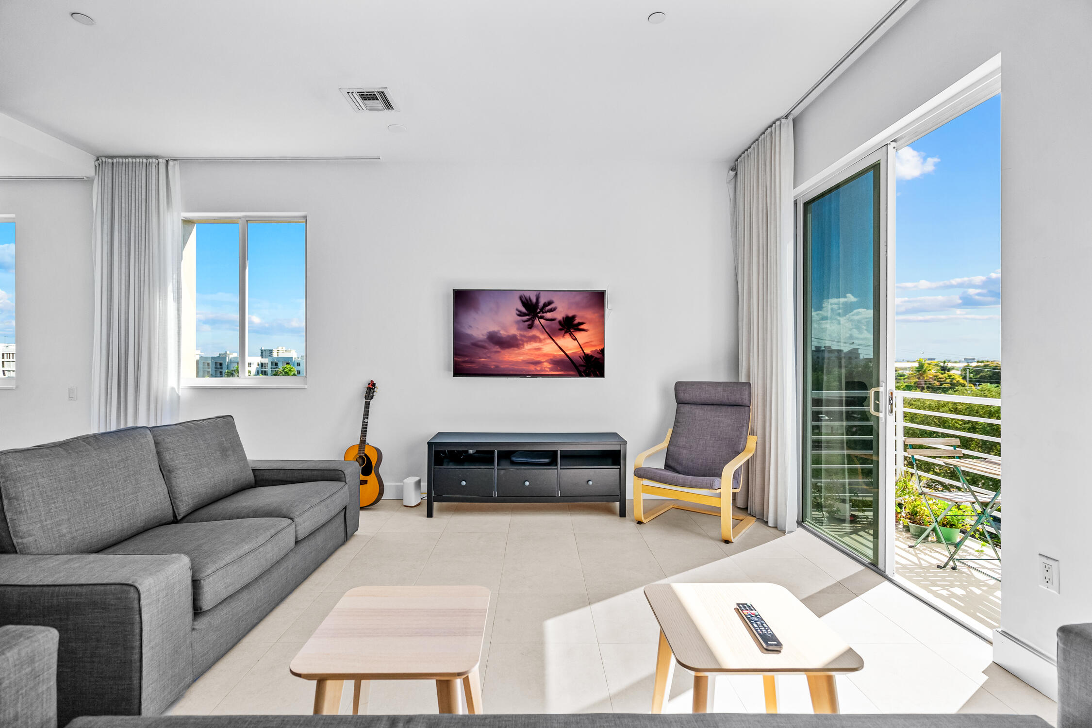 111 Southeast 2nd Street, Unit 401 Delray Beach, FL 33444 - Photo 10 of 38 a living room with furniture and a flat screen tv