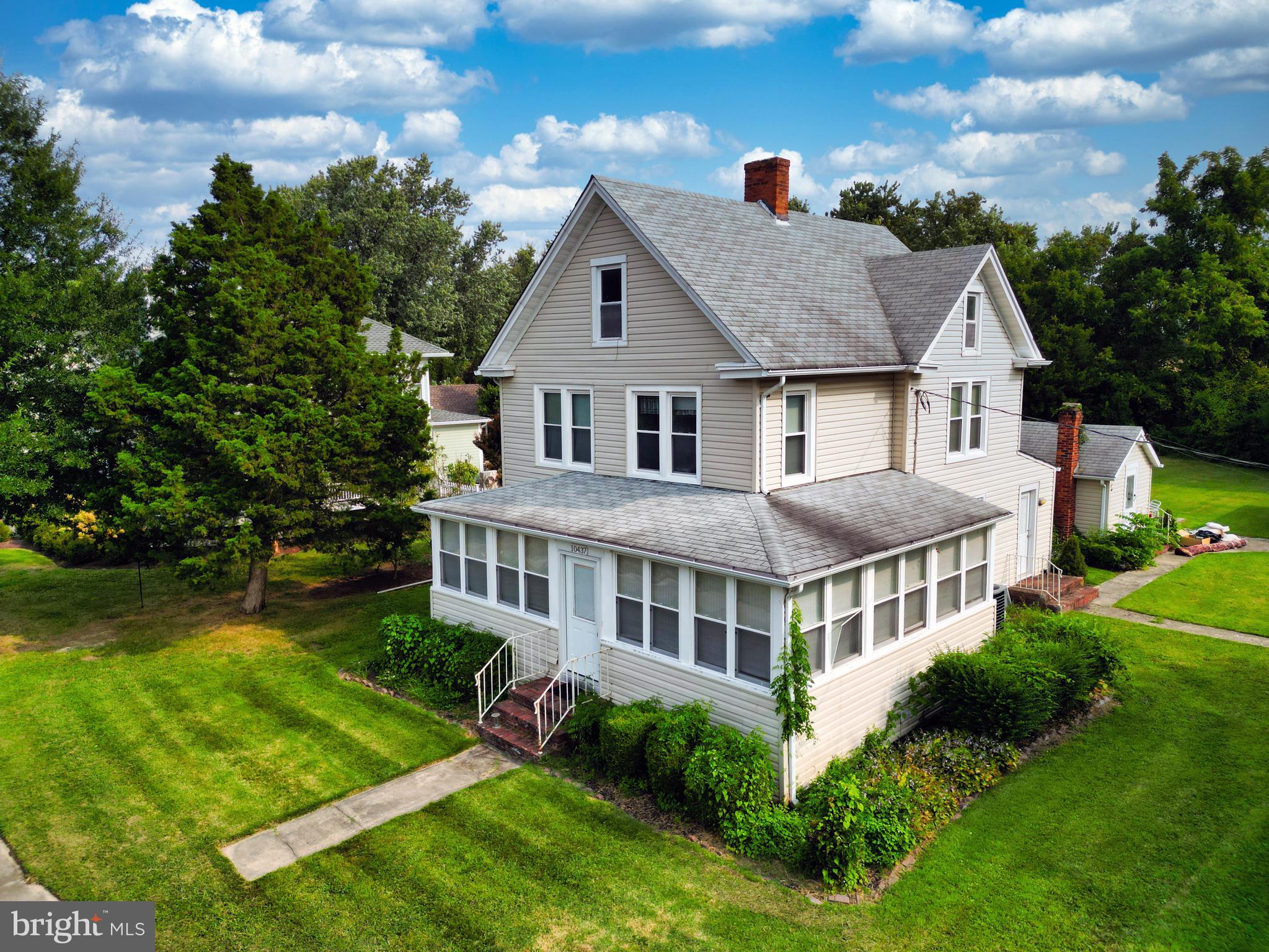 10437 Main Street Claiborne, MD 21624 - Photo 11 of 44 a aerial view of a house with a yard and potted plants