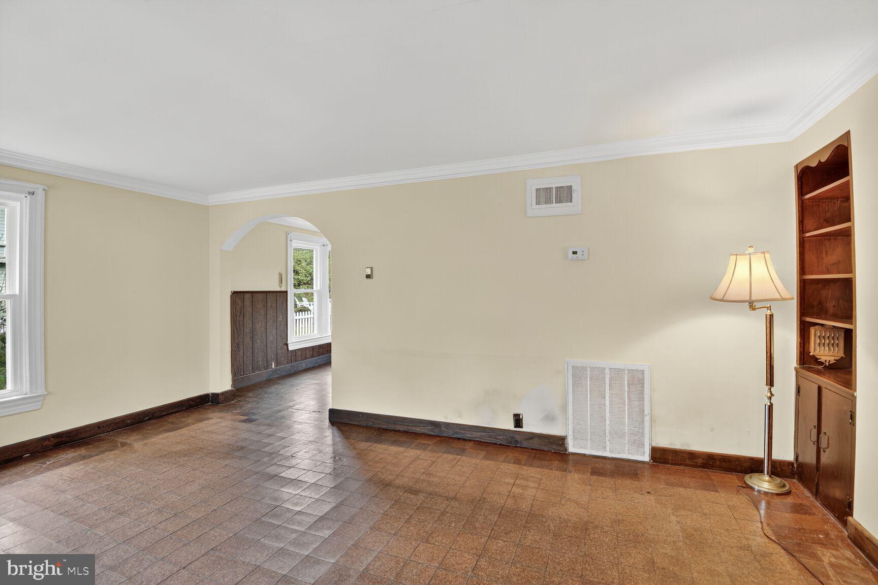 10437 Main Street Claiborne, MD 21624 - Photo 13 of 44 an empty room with wooden floor and windows