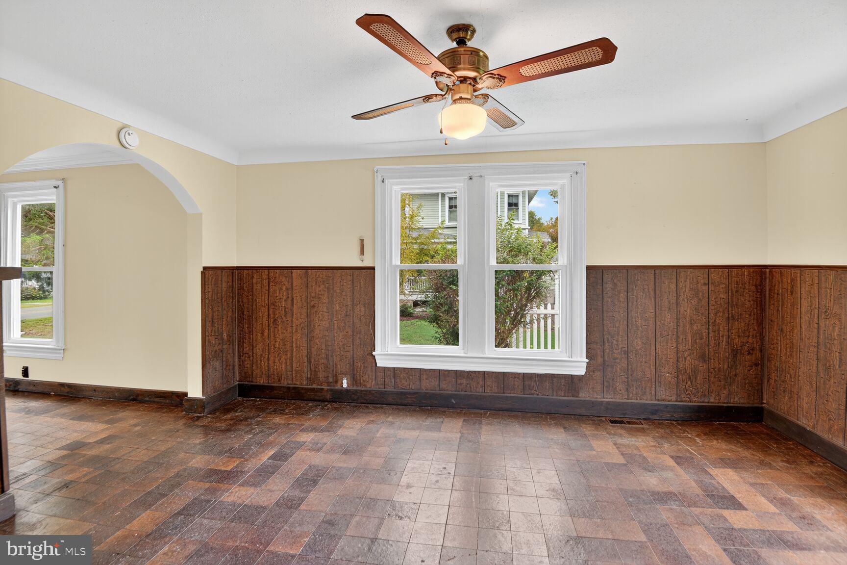 10437 Main Street Claiborne, MD 21624 - Photo 18 of 44 an empty room with wooden floor and windows