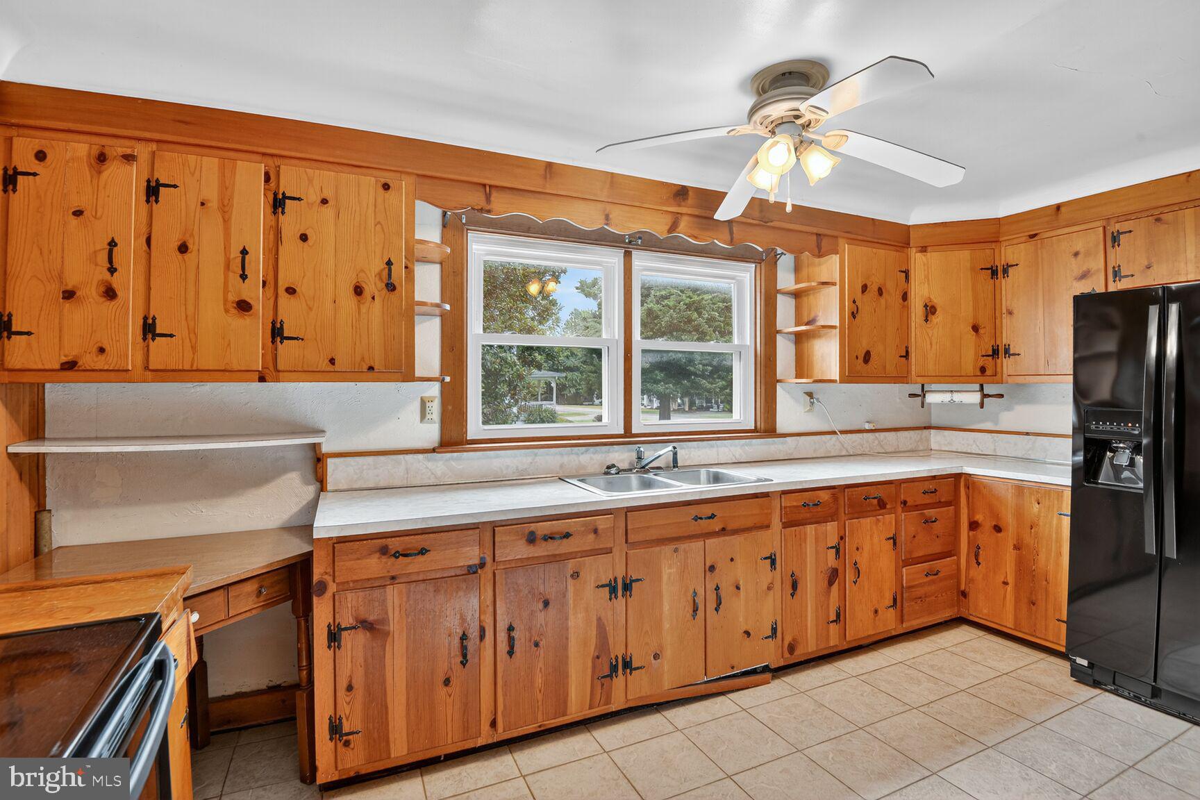 10437 Main Street Claiborne, MD 21624 - Photo 19 of 44 a kitchen with stainless steel appliances granite countertop a sink and cabinets