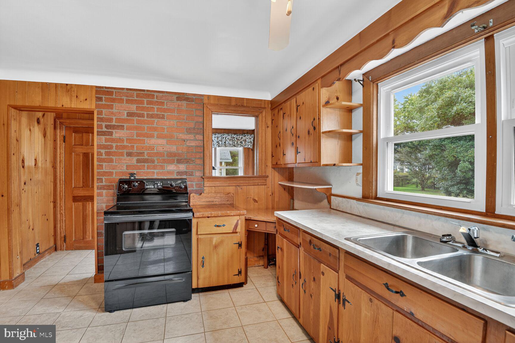 10437 Main Street Claiborne, MD 21624 - Photo 20 of 44 a kitchen with a sink stove and cabinets