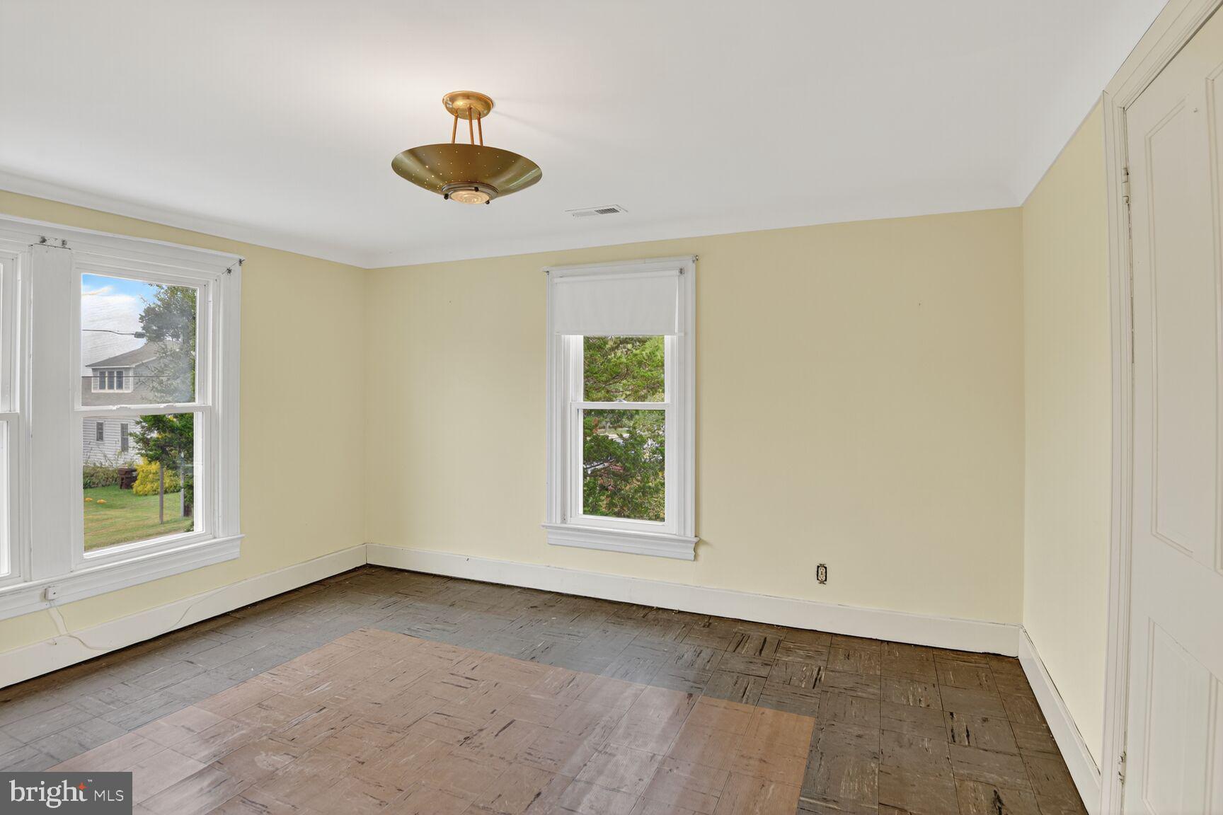 10437 Main Street Claiborne, MD 21624 - Photo 21 of 44 wooden floor in an empty room with a window