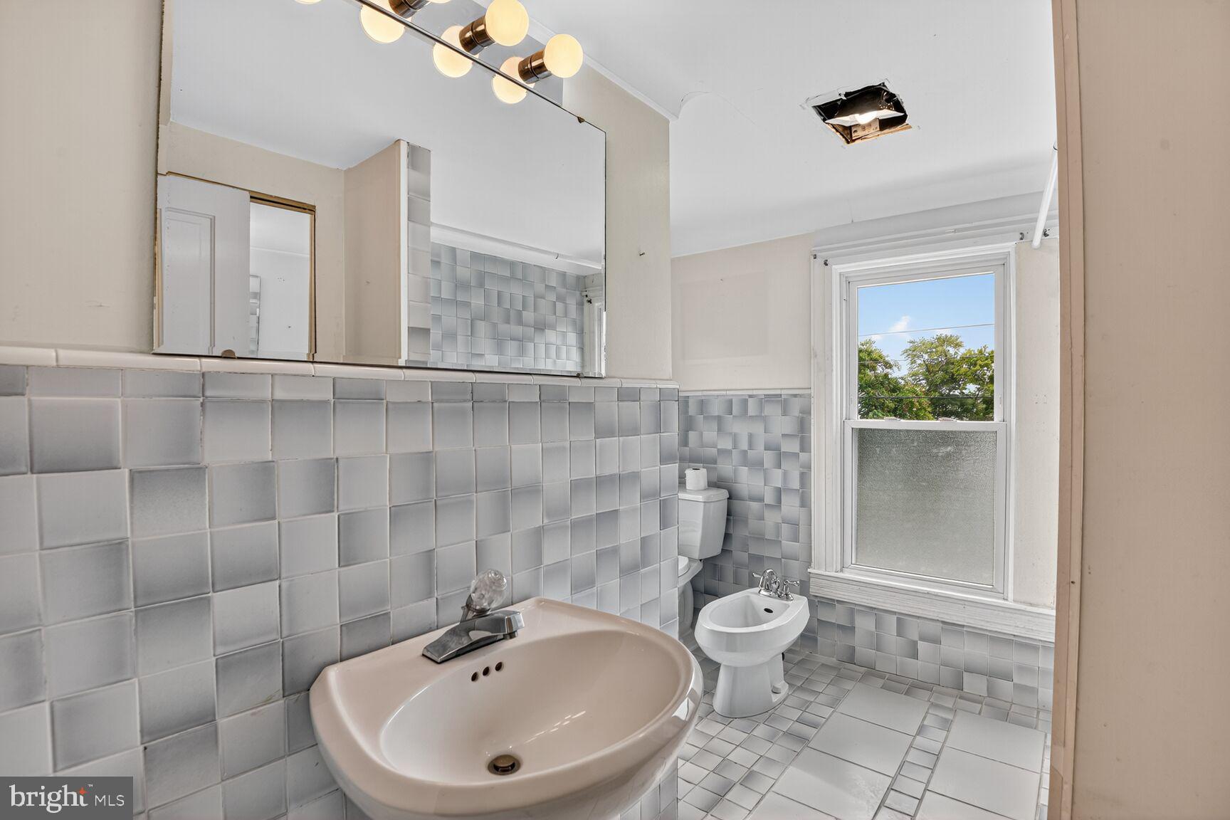 10437 Main Street Claiborne, MD 21624 - Photo 22 of 44 a bathroom with a sink and mirror