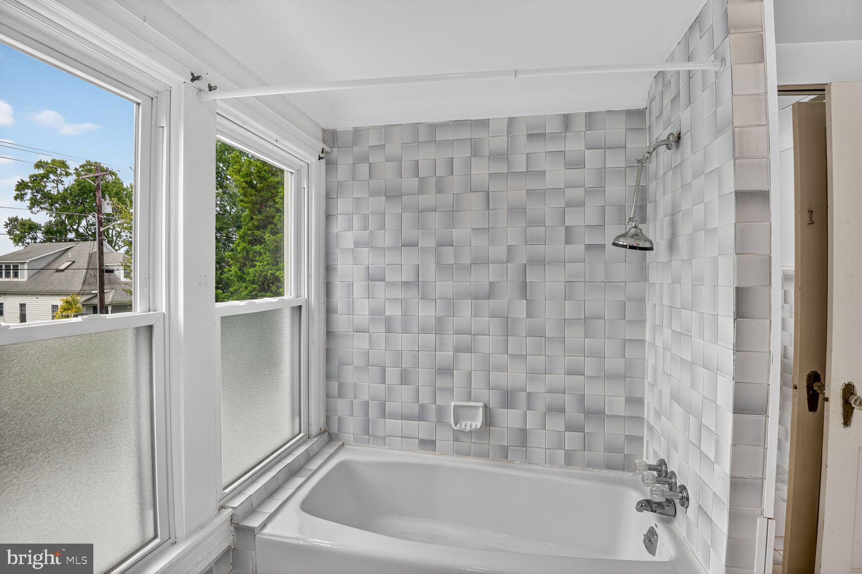 10437 Main Street Claiborne, MD 21624 - Photo 23 of 44 a bathroom with a bathtub and shower