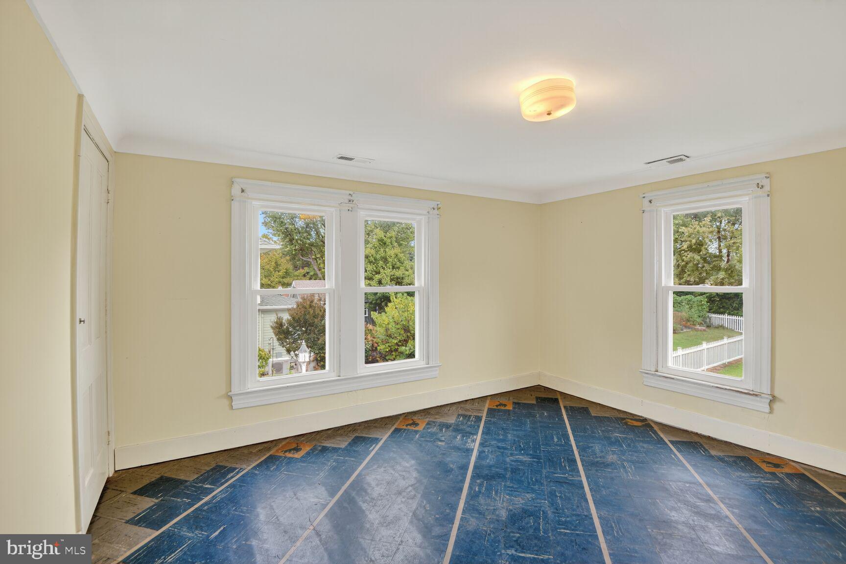 10437 Main Street Claiborne, MD 21624 - Photo 25 of 44 an empty room with wooden floor and windows
