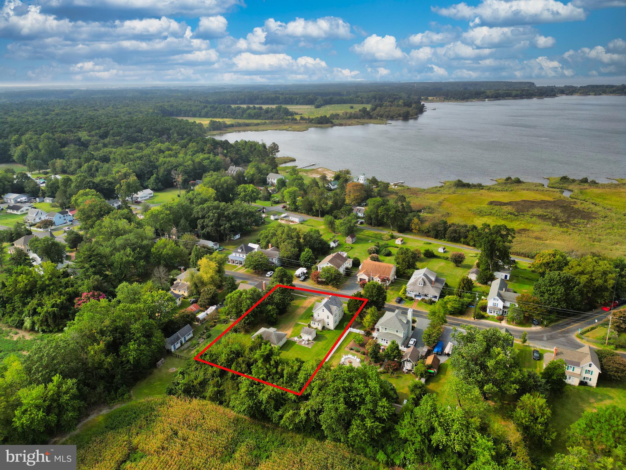 10437 Main Street Claiborne, MD 21624 - Photo 3 of 44 a view of a lake with houses in back