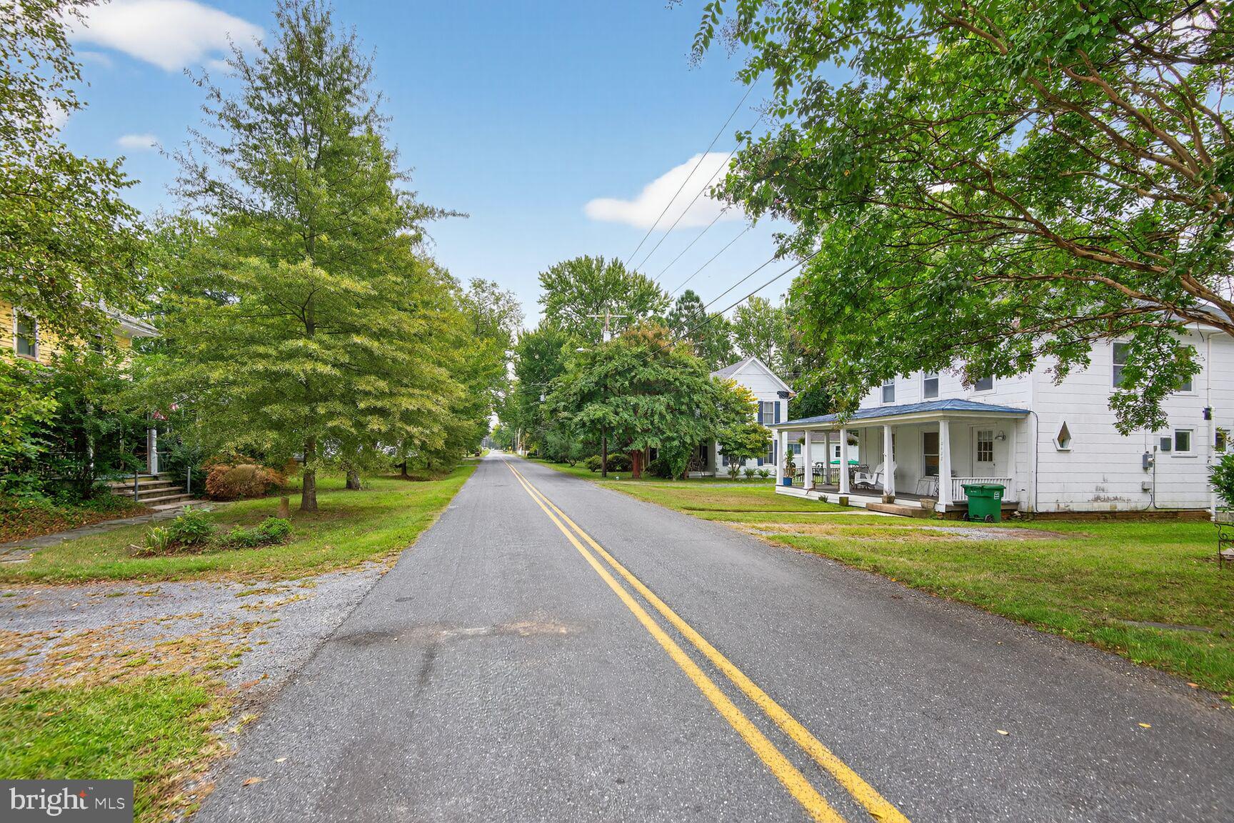 10437 Main Street Claiborne, MD 21624 - Photo 38 of 44 a view of a house with a yard and basketball court